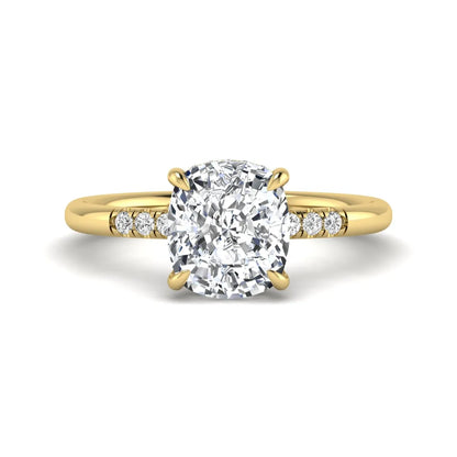 Cushion hidden halo lab grown diamond engagement ring featuring a 2.35 carat cushion cut center diamond with round accent diamonds on a yellow gold band.