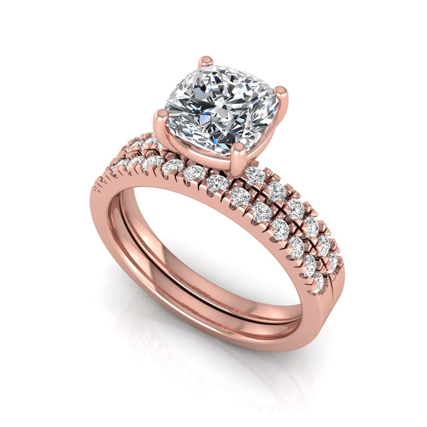 Cushion cut lab grown diamond bridal ring set featuring a four-prong solitaire engagement ring with pavé round diamond accents and matching wedding band in rose gold finish.