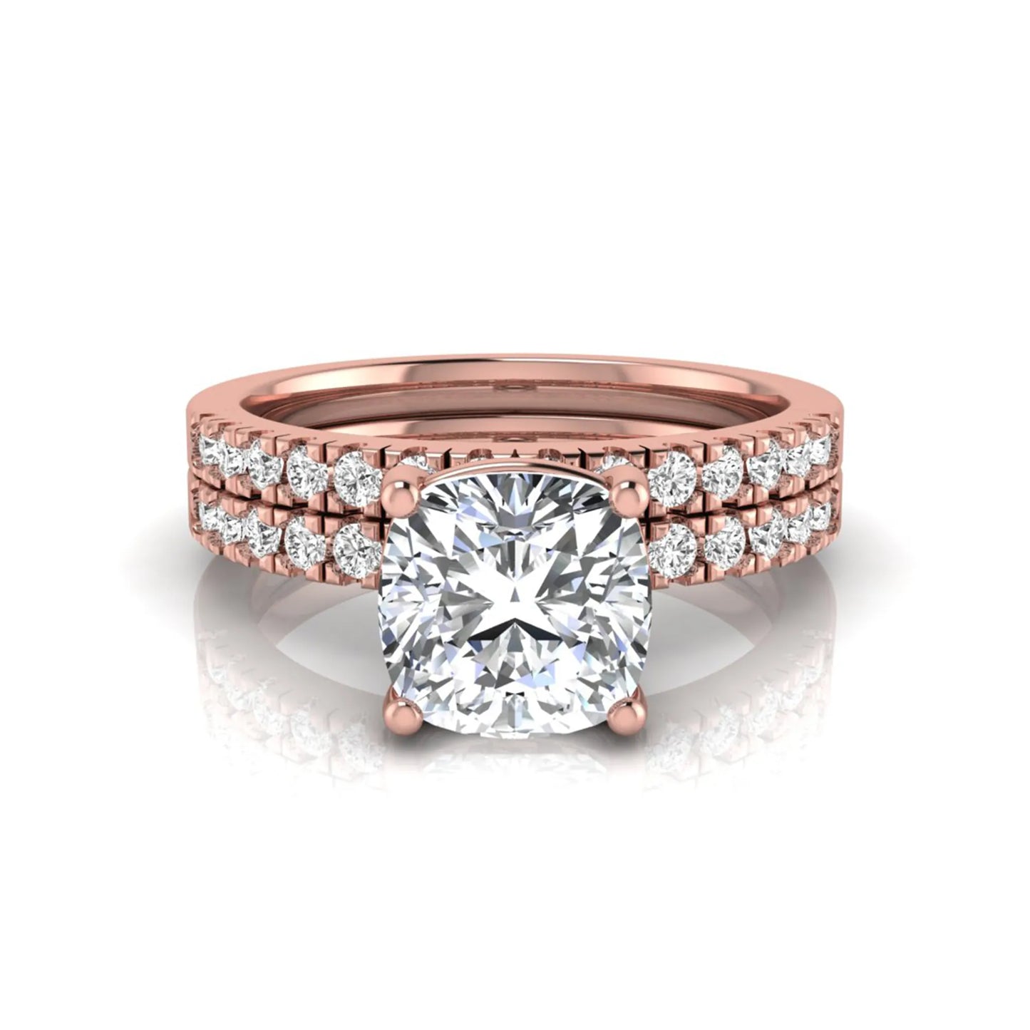 Cushion cut lab grown diamond bridal ring set featuring a four-prong solitaire engagement ring with pavé round diamond accents and matching wedding band in rose gold finish.