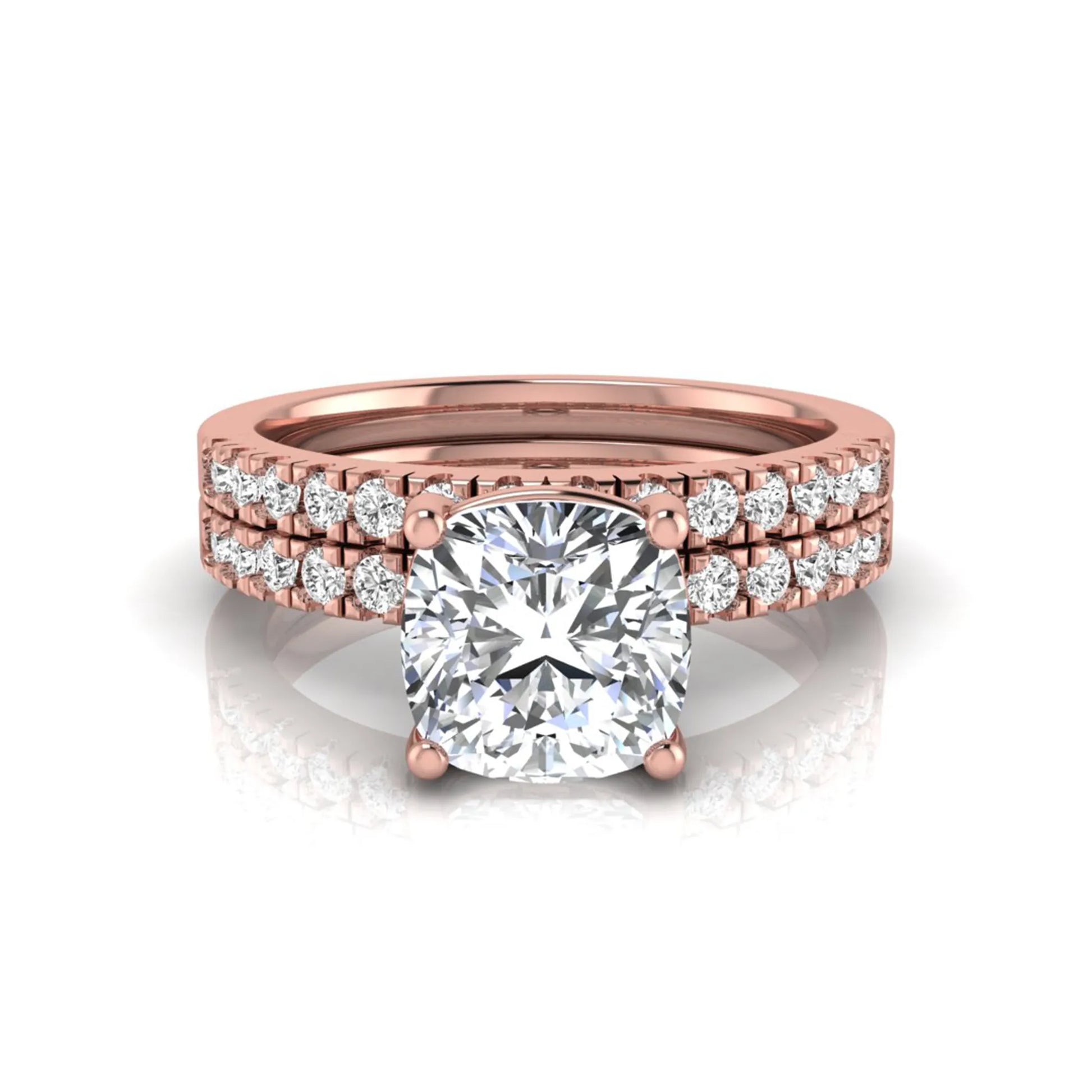 Cushion cut lab grown diamond bridal ring set featuring a four-prong solitaire engagement ring with pavé round diamond accents and matching wedding band in rose gold finish.