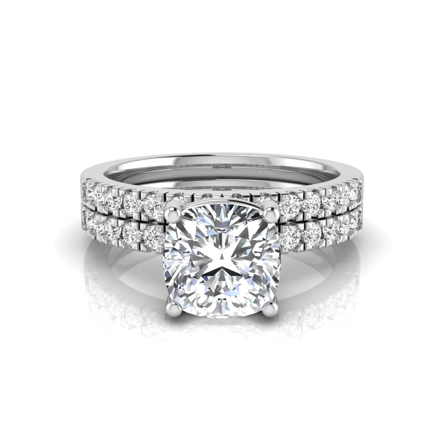 Cushion cut lab grown diamond bridal ring set featuring a four-prong solitaire engagement ring with pavé round diamond accents and matching wedding band in white gold finish.