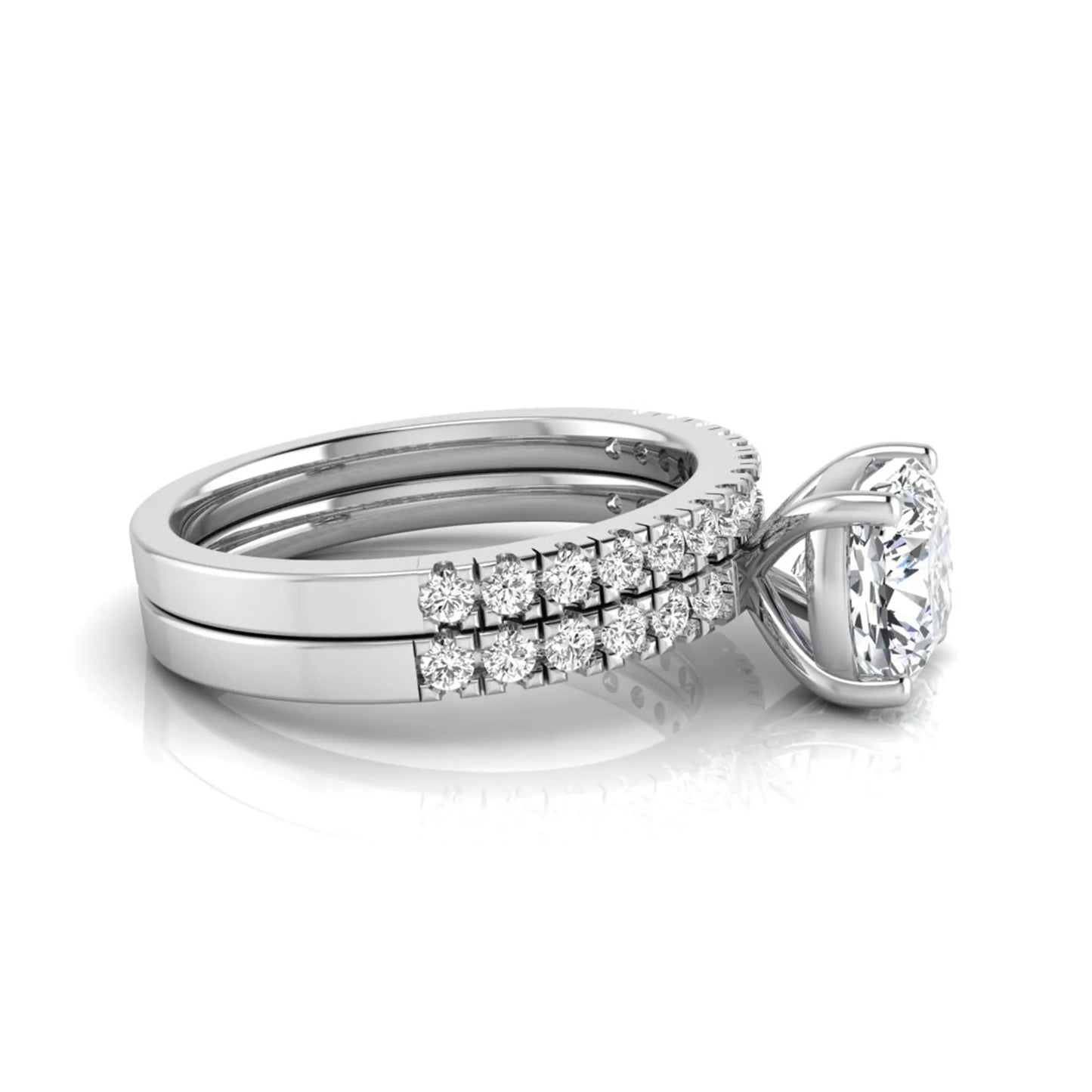 Cushion cut lab grown diamond bridal ring set featuring a four-prong solitaire engagement ring with pavé round diamond accents and matching wedding band in white gold finish.