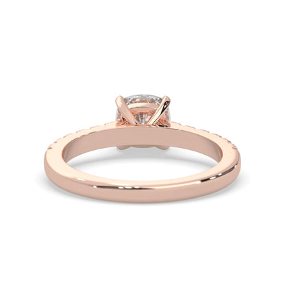 Cushion cut lab grown diamond prong set engagement ring with pavé band and rose gold metal tone design