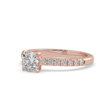 Cushion cut lab grown diamond prong set engagement ring with pavé band and rose gold metal tone design