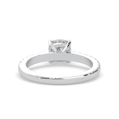 Cushion cut lab grown diamond prong set engagement ring with pavé band and white gold metal tone design