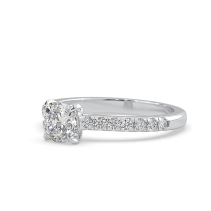 Cushion cut lab grown diamond prong set engagement ring with pavé band and white gold metal tone design