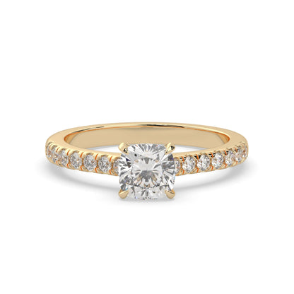 Cushion cut lab grown diamond prong set engagement ring with pavé band and yellow gold metal tone design