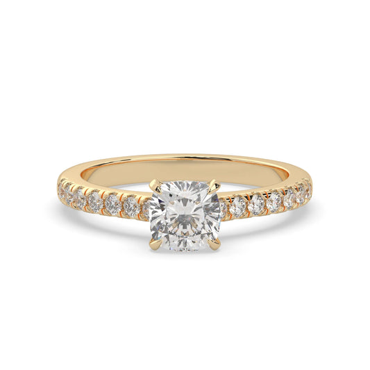 Cushion cut lab grown diamond prong set engagement ring with pavé band and yellow gold metal tone design