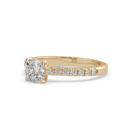 Cushion cut lab grown diamond prong set engagement ring with pavé band and yellow gold metal tone design