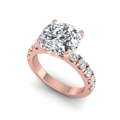 Cushion cut lab grown diamond solitaire engagement ring featuring a four-prong setting with a shared prong round diamond band in a rose gold tone design.