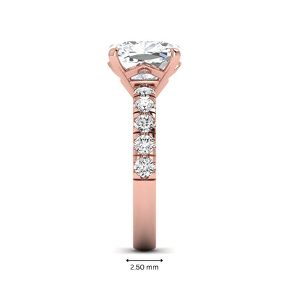 Cushion cut lab grown diamond solitaire engagement ring featuring a four-prong setting with a shared prong round diamond band in a rose gold tone design.