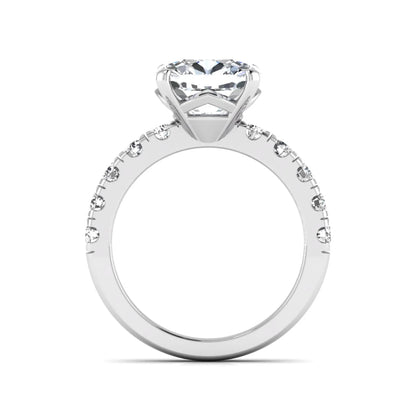Cushion cut lab grown diamond solitaire engagement ring featuring a four-prong setting with a shared prong round diamond band in a white gold tone design.
