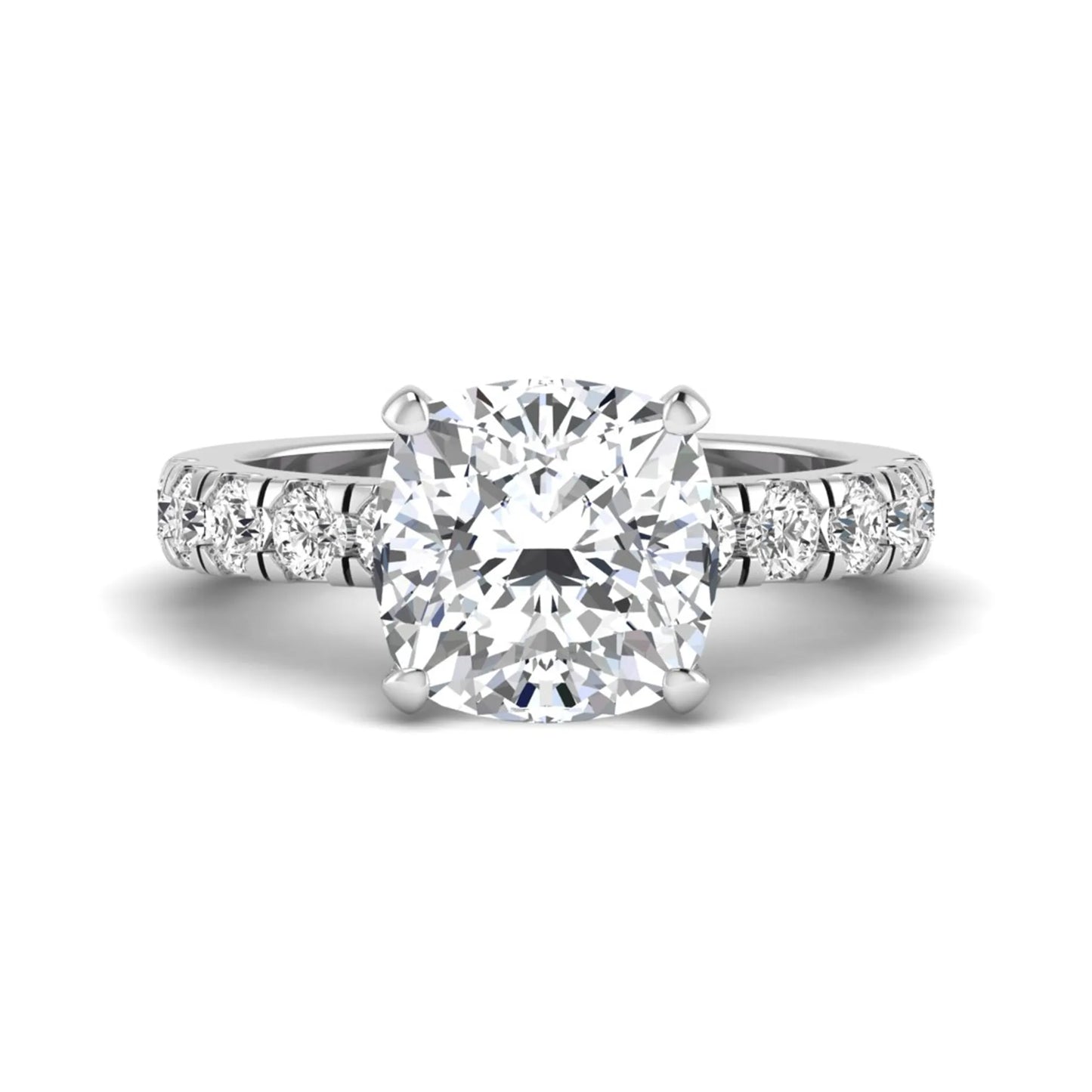 Cushion cut lab grown diamond solitaire engagement ring featuring a four-prong setting with a shared prong round diamond band in a white gold tone design.