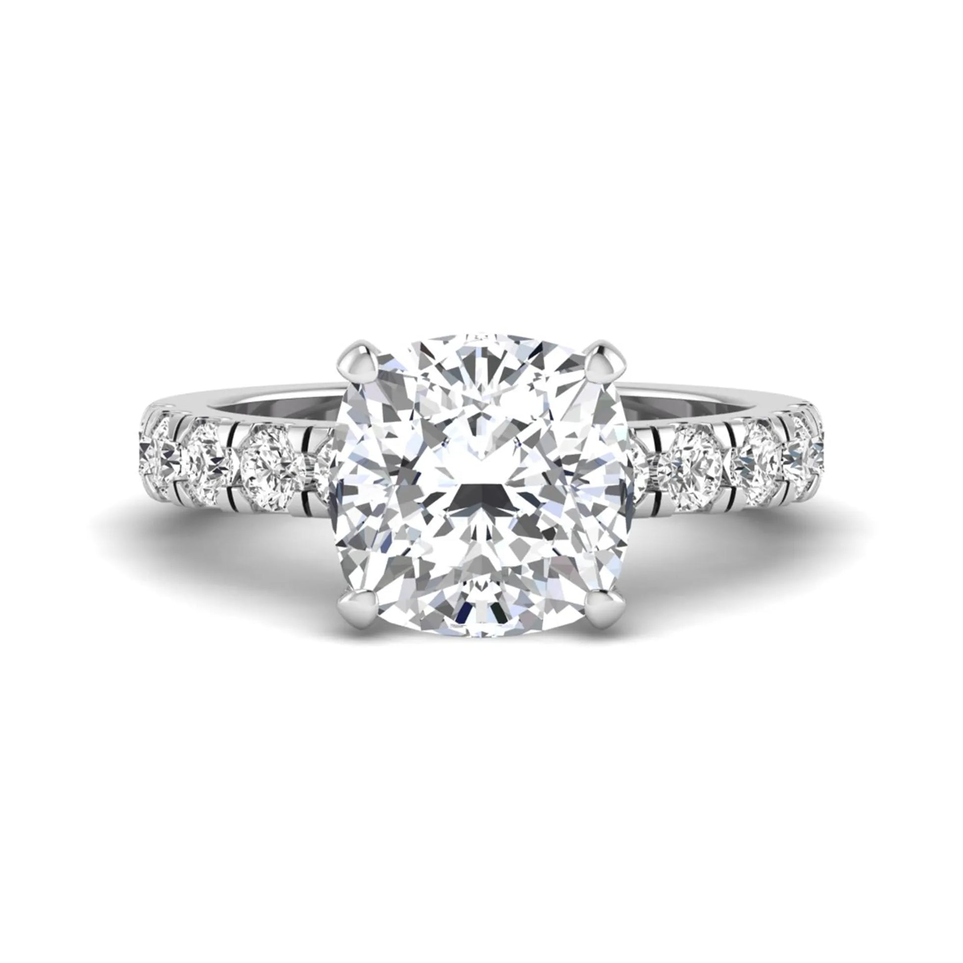 Cushion cut lab grown diamond solitaire engagement ring featuring a four-prong setting with a shared prong round diamond band in a white gold tone design.