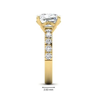 Cushion cut lab grown diamond solitaire engagement ring featuring a four-prong setting with a shared prong round diamond band in a yellow gold tone design.