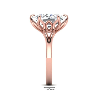 Elongated cushion cut lab grown diamond solitaire engagement ring featuring a four-prong setting with a split cathedral shank in a rose gold tone design.
