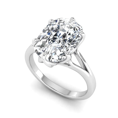 Elongated cushion cut lab grown diamond solitaire engagement ring featuring a four-prong setting with a split cathedral shank in a white gold tone design.