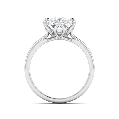 Elongated cushion cut lab grown diamond solitaire engagement ring featuring a four-prong setting with a split cathedral shank in a white gold tone design.