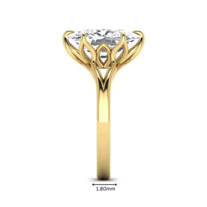 Elongated cushion cut lab grown diamond solitaire engagement ring featuring a four-prong setting with a split cathedral shank in a yellow gold tone design.