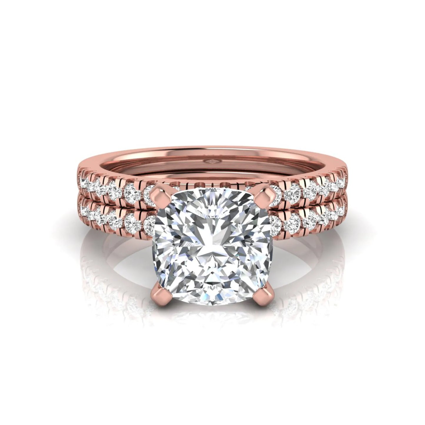 Cushion cut lab grown diamond solitaire engagement ring with matching pavé diamond wedding band in rose gold.