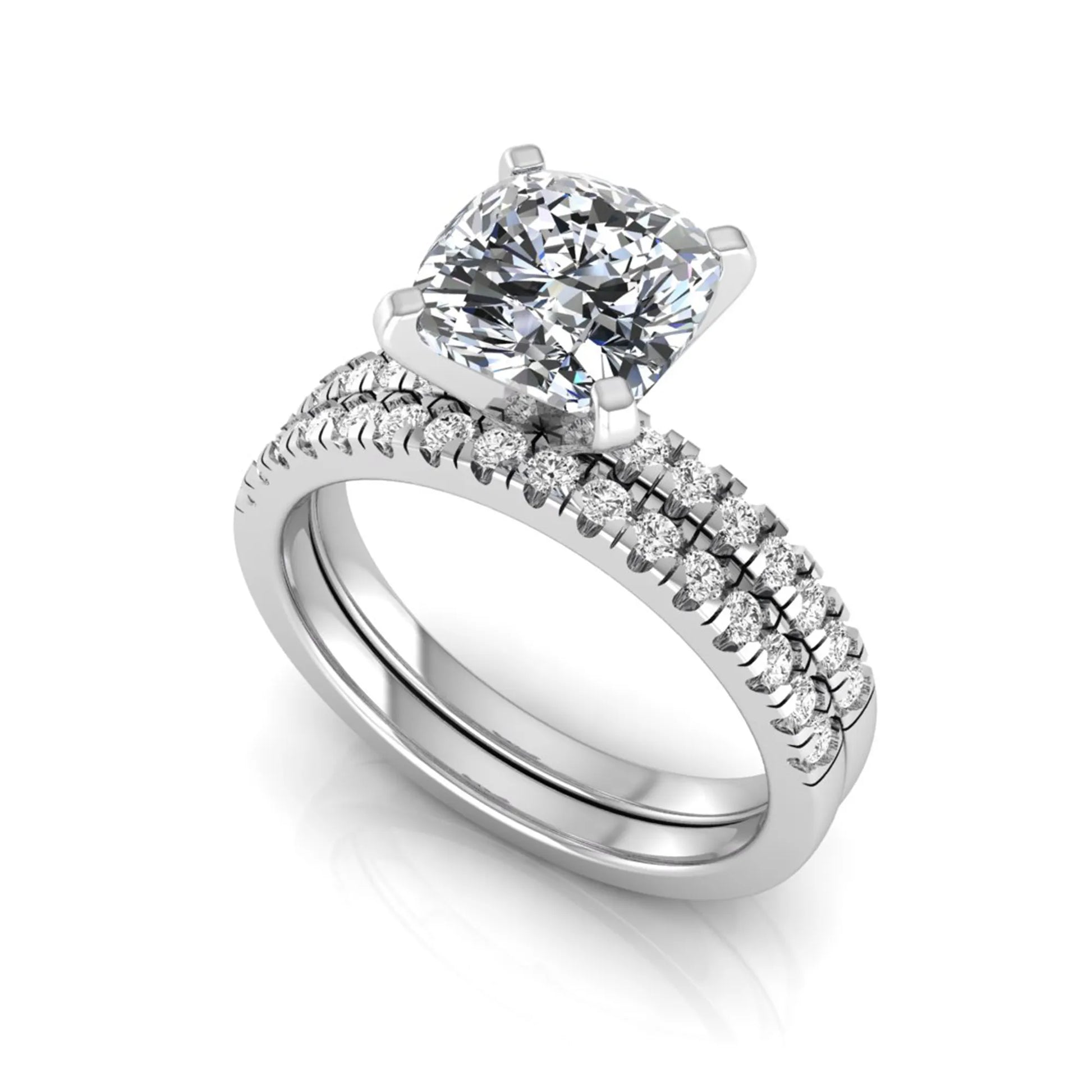 Cushion cut lab grown diamond solitaire engagement ring with matching pavé diamond wedding band in white gold.