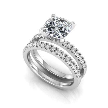 Cushion cut lab grown diamond solitaire engagement ring with matching pavé diamond wedding band in white gold.