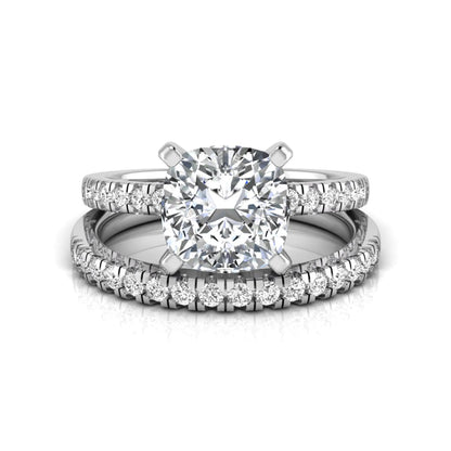 Cushion cut lab grown diamond solitaire engagement ring with matching pavé diamond wedding band in white gold.