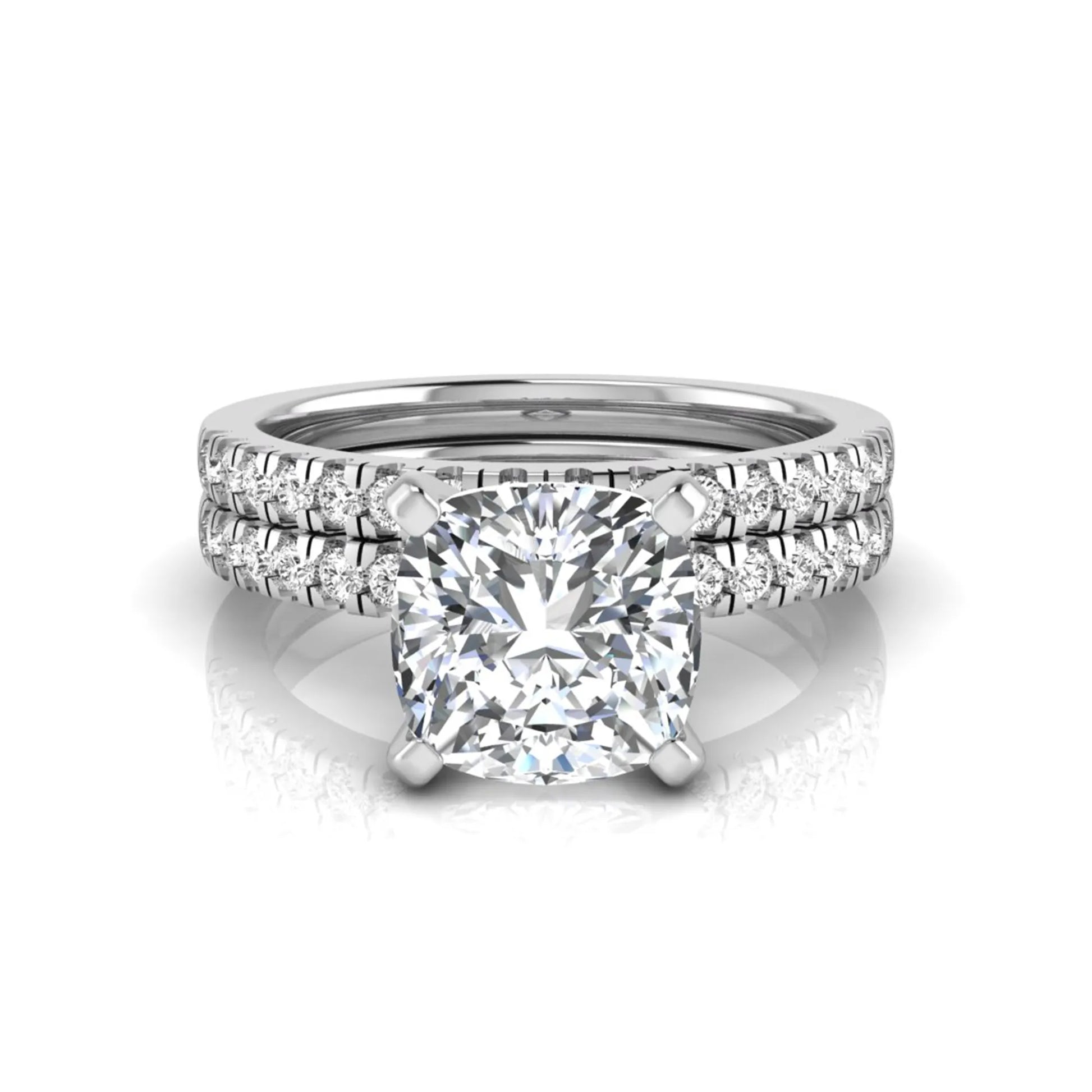 Cushion cut lab grown diamond solitaire engagement ring with matching pavé diamond wedding band in white gold.