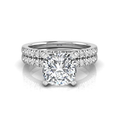 Cushion cut lab grown diamond solitaire engagement ring with matching pavé diamond wedding band in white gold.