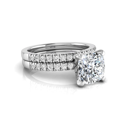 Cushion cut lab grown diamond solitaire engagement ring with matching pavé diamond wedding band in white gold.