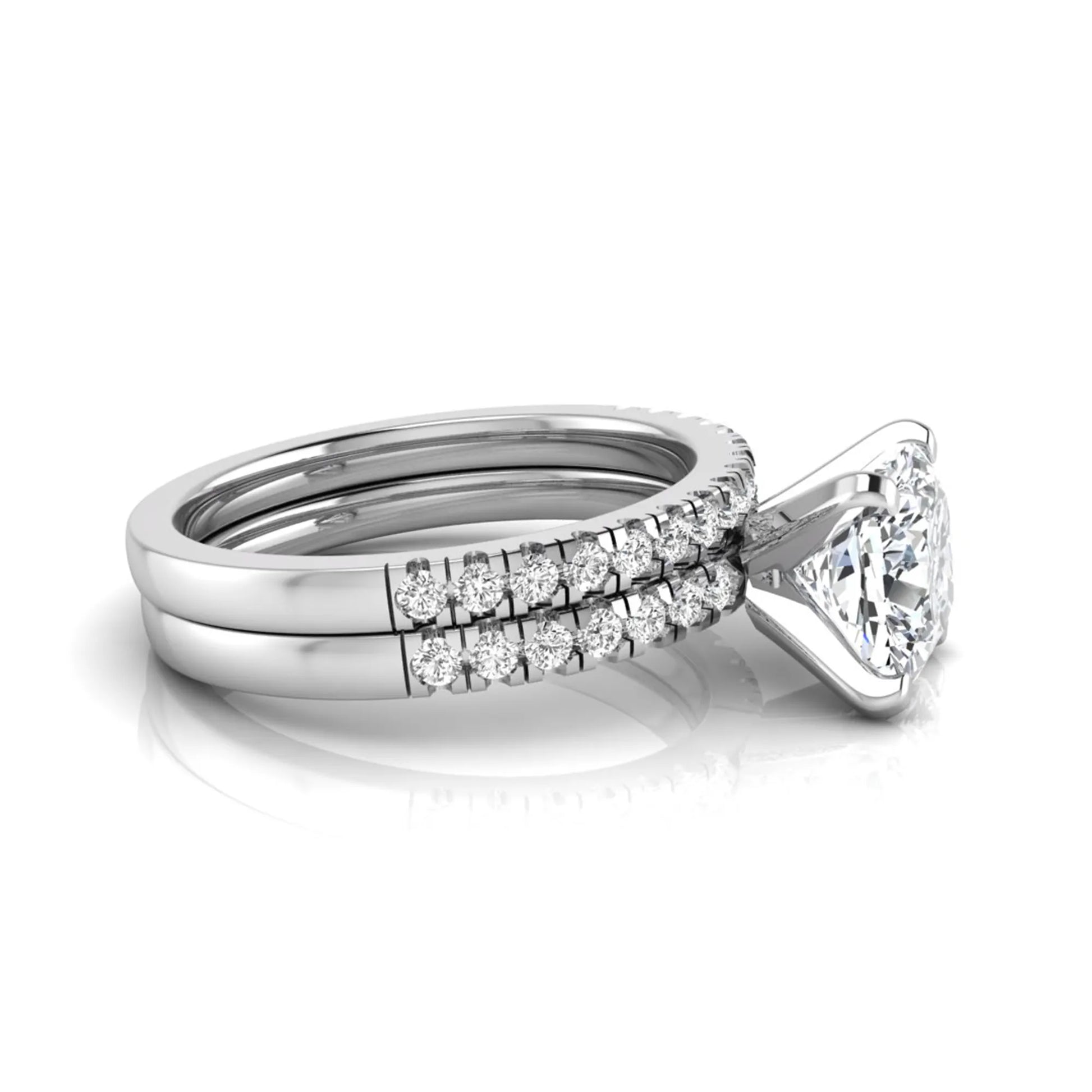Cushion cut lab grown diamond solitaire engagement ring with matching pavé diamond wedding band in white gold.