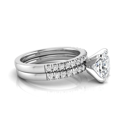 Cushion cut lab grown diamond solitaire engagement ring with matching pavé diamond wedding band in white gold.