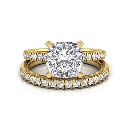 Cushion cut lab grown diamond solitaire engagement ring with matching pavé diamond wedding band in yellow gold.