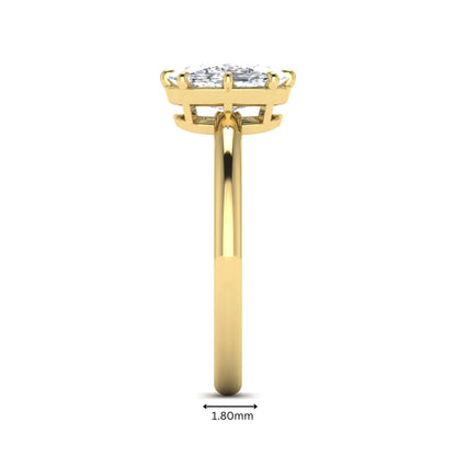 Cushion cut lab grown diamond solitaire engagement ring featuring an eight-prong setting with a polished yellow gold band.