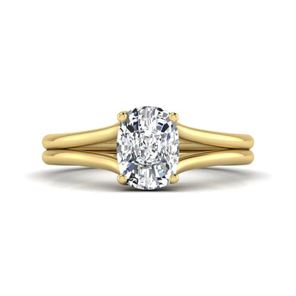Cushion cut lab grown diamond solitaire engagement ring featuring a split shank band and four-prong setting in polished yellow gold.