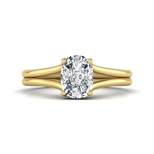 Cushion cut lab grown diamond solitaire engagement ring featuring a split shank band and four-prong setting in polished yellow gold.