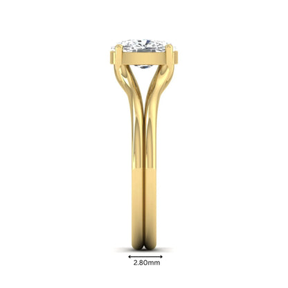 Cushion cut lab grown diamond solitaire engagement ring featuring a split shank band and four-prong setting in polished yellow gold.