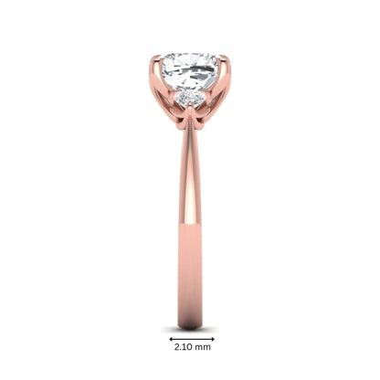 Cushion cut three stone lab grown diamond engagement ring featuring a 1.67 carat IGI certified center diamond with pear side diamonds in rose gold.