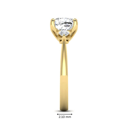Cushion cut three stone lab grown diamond engagement ring featuring a 1.67 carat IGI certified center diamond with pear side diamonds in yellow gold.