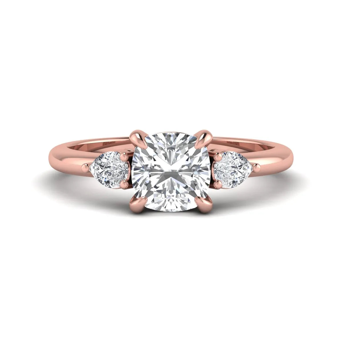 Cushion cut lab grown diamond three stone engagement ring with pear cut side diamonds in a classic prong setting in rose gold