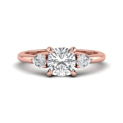 Cushion cut lab grown diamond three stone engagement ring with pear cut side diamonds in a classic prong setting in rose gold