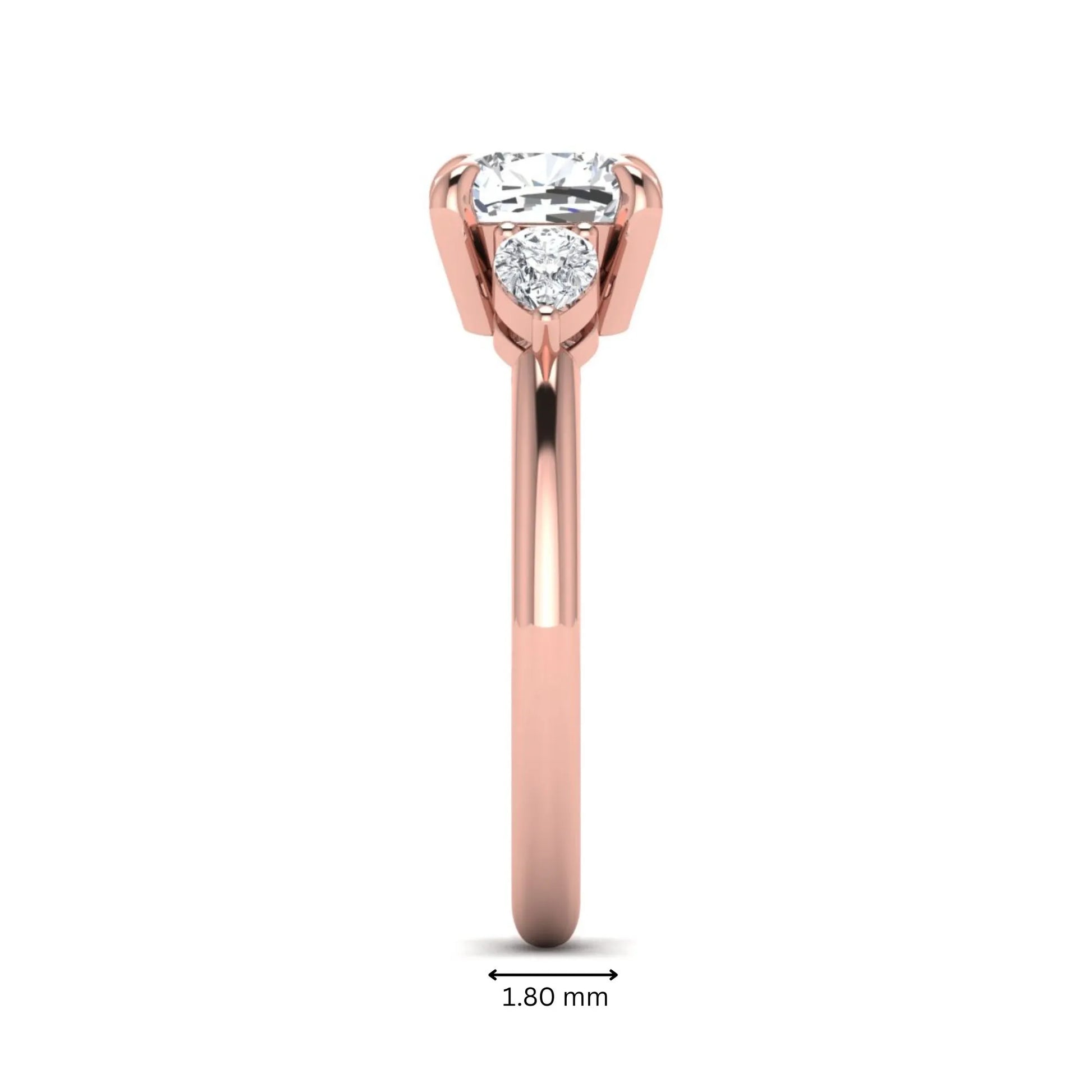 Cushion cut lab grown diamond three stone engagement ring with pear cut side diamonds in a classic prong setting in rose gold