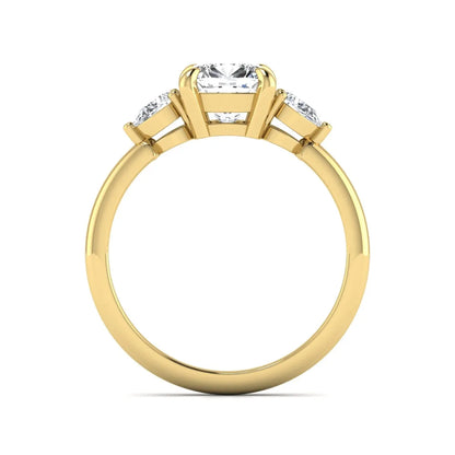 Cushion cut lab grown diamond three stone engagement ring with pear cut side diamonds in a classic prong setting in yellow gold