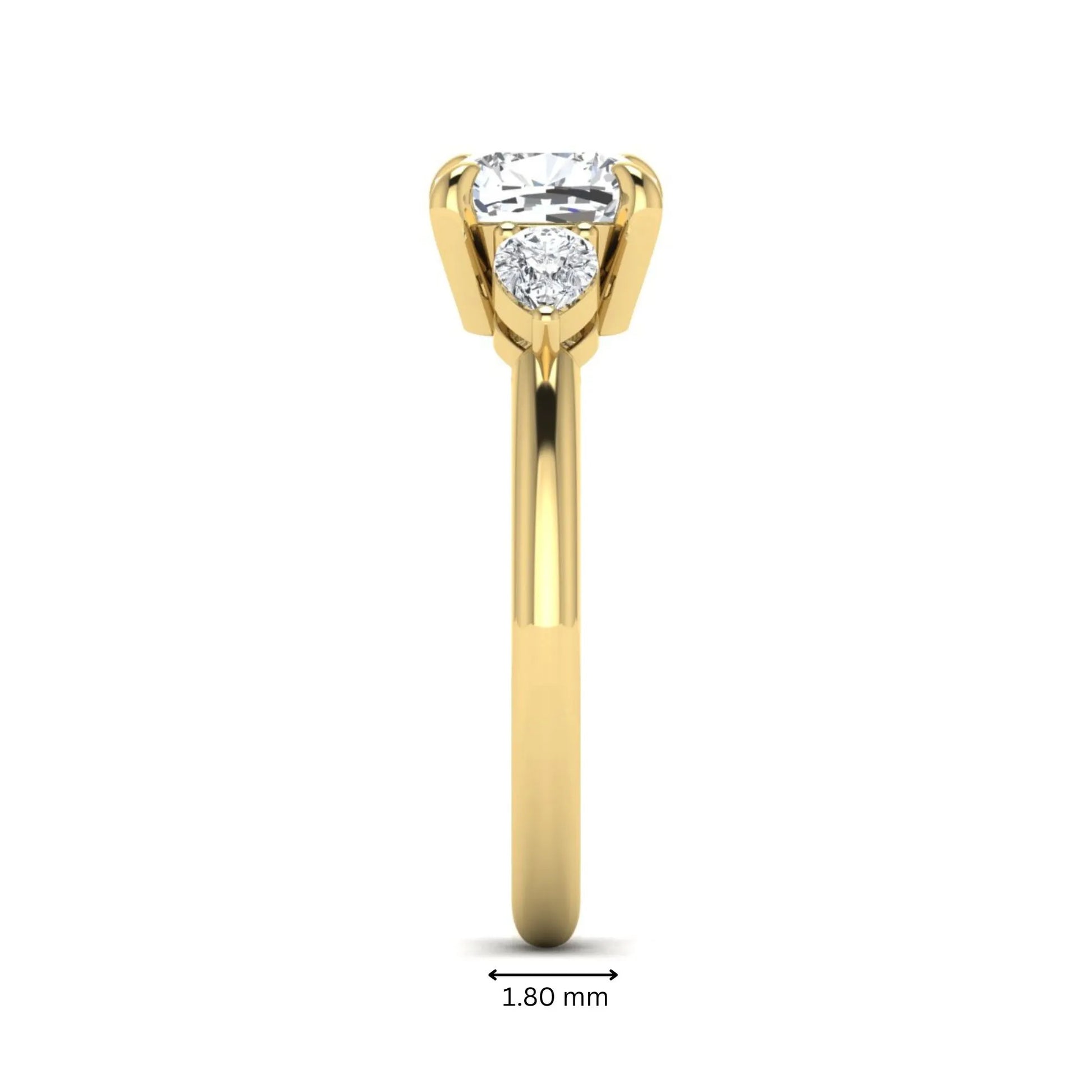 Cushion cut lab grown diamond three stone engagement ring with pear cut side diamonds in a classic prong setting in yellow gold
