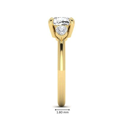 Cushion cut lab grown diamond three stone engagement ring with pear cut side diamonds in a classic prong setting in yellow gold