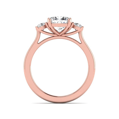Cushion cut lab grown diamond three stone engagement ring featuring a cushion center diamond with round brilliant side diamonds on a polished rose gold band.