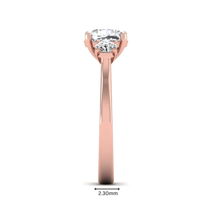 Cushion cut lab grown diamond three stone engagement ring featuring a cushion center diamond with round brilliant side diamonds on a polished rose gold band.