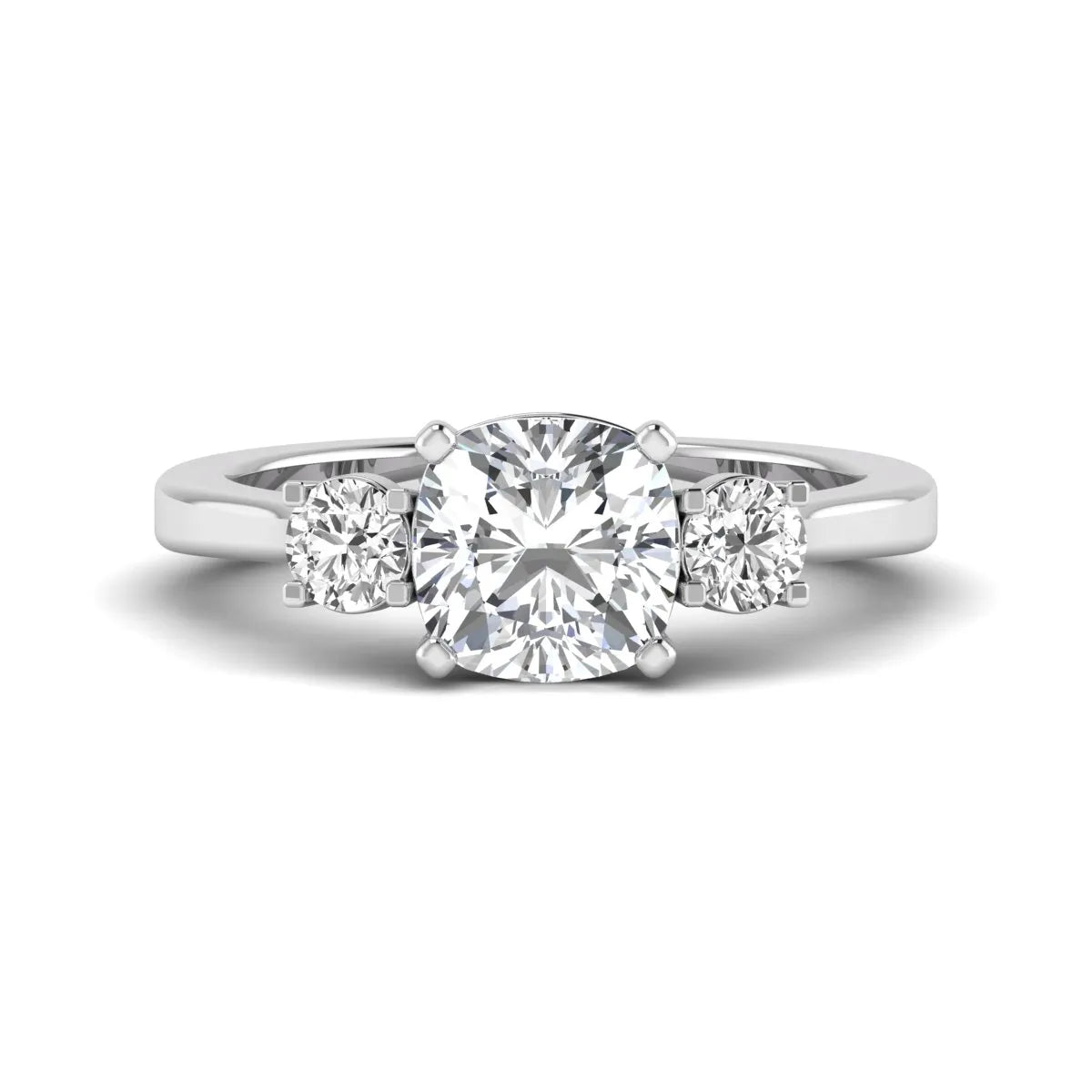 Cushion cut lab grown diamond three stone engagement ring featuring a cushion center diamond with round brilliant side diamonds on a polished white gold band.