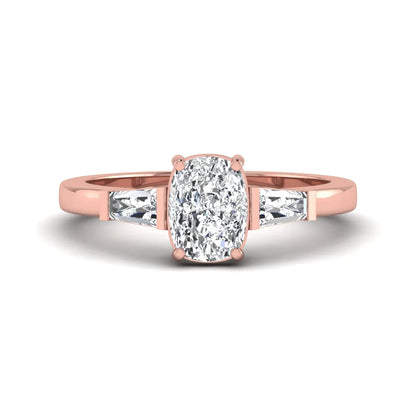 Cushion cut lab grown diamond three stone engagement ring with baguette side diamonds in a four prong setting and rose gold tone band.