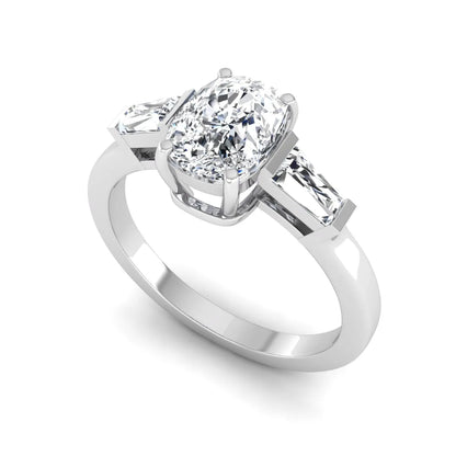 Cushion cut lab grown diamond three stone engagement ring with baguette side diamonds in a four prong setting and white gold tone band.